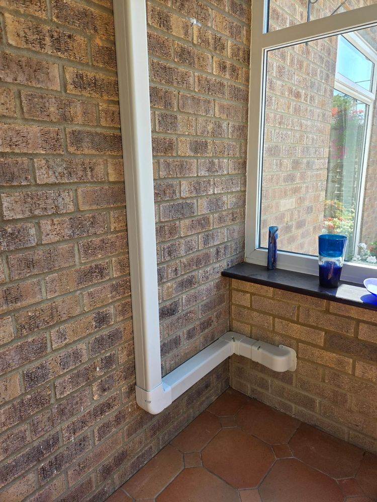 Refrigerant pipework run neatly along an exterior wall