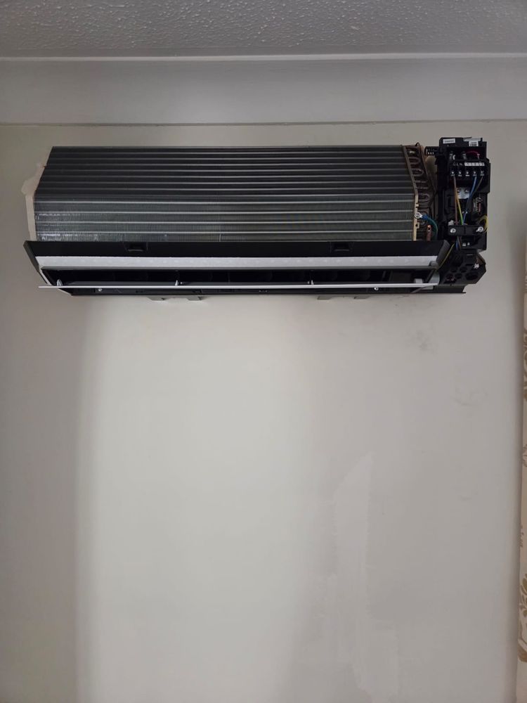 Indoor unit with the full casing removed, coil and wiring exposed