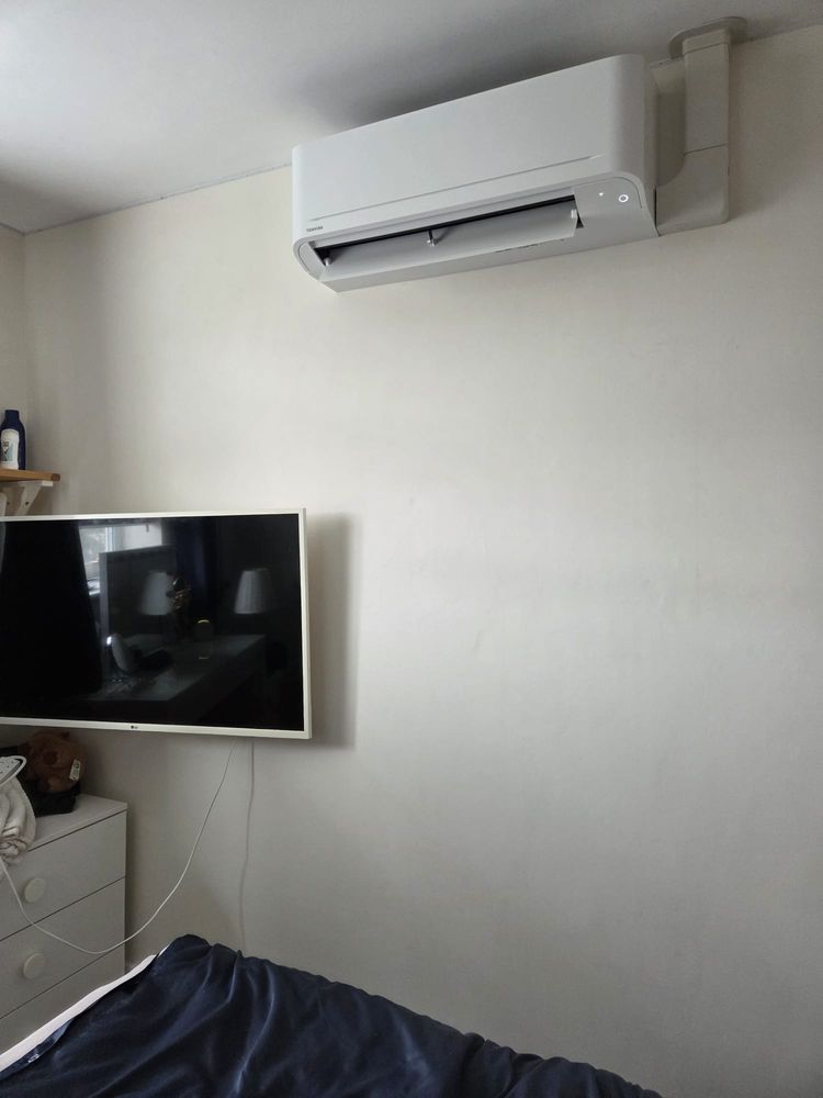 Indoor unit mounted above a wall-hung television